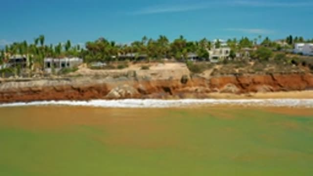 SAN JOSE DEL CABO MEXICO-2020: The Green Sea Water Hitting The Beach
