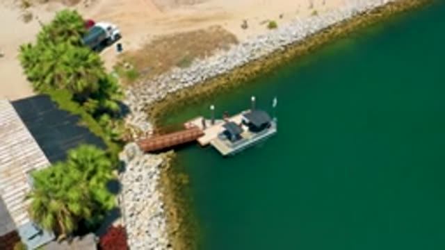 SAN JOSE DEL CABO MEXICO-2020: Two Humans Stepping Onto Boat Off The Rocky Shore