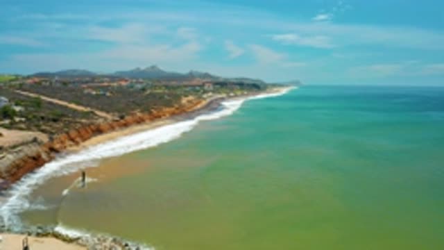 SAN JOSE DEL CABO MEXICO-2020: A Blue Green Sea Is Washing Against A Beach On A