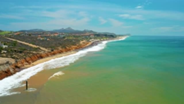 SAN JOSE DEL CABO MEXICO-2020: Sea Water Washes Against Shore Filled With Plants