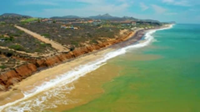 SAN JOSE DEL CABO MEXICO-2020: Flyover Of Body Of Water Meeting An Island Rock