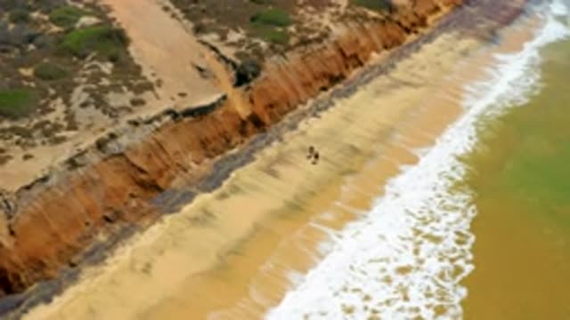 SAN JOSE DEL CABO MEXICO-2020: Two Young Men Walk Lastly In The Long Beach With