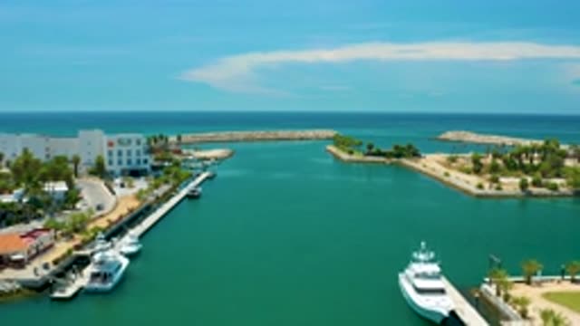 SAN JOSE DEL CABO MEXICO-2020: Tall White Building Near The Sea Shore With Ships