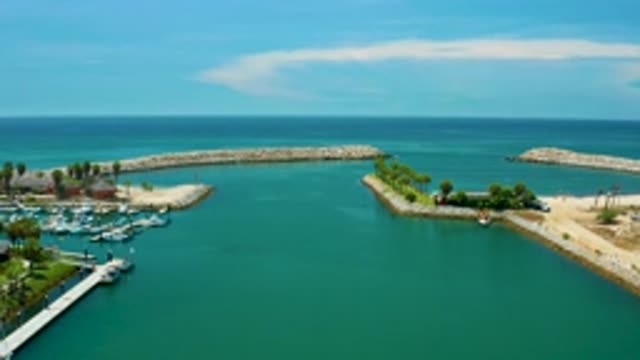 SAN JOSE DEL CABO MEXICO-2020: Emerald Green Lagoon Opening Out Into Ocean With Yachts and Palm Trees