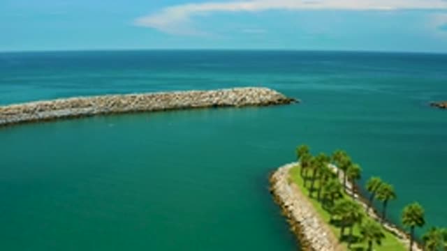 SAN JOSE DEL CABO MEXICO-2020: Two Strips Of Land With Palm Trees Float By In A