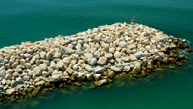 SAN JOSE DEL CABO MEXICO-2020: Aerial View Of Dam Of Stones In A Sea Of Clear