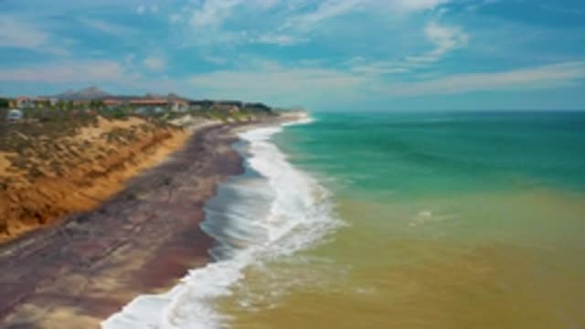 SAN JOSE DEL CABO MEXICO-2020: Camera Panning Over Ocean Shoreline With Sandy