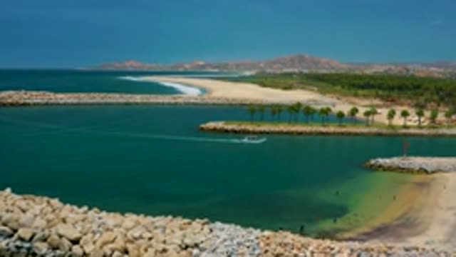 SAN JOSE DEL CABO MEXICO-2020: Streamer Boat Running in the Sea Near White Stone Shore