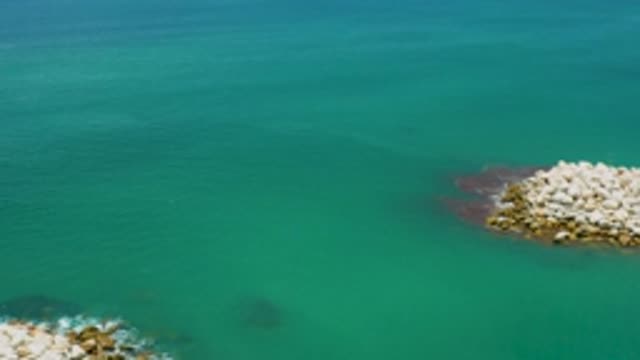 SAN JOSE DEL CABO MEXICO-2020: Plentiful Rocks Sit Atop and Below Murky Waters