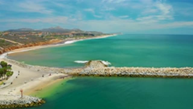 SAN JOSE DEL CABO MEXICO-2020: Waves Crash Gently Midst The Sand Bar At The Beach