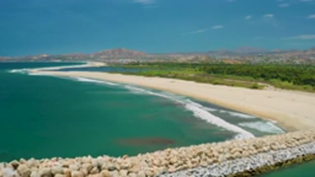 SAN JOSE DEL CABO MEXICO-2020: Panning Over Rocks Towards Blue Waves And Beach