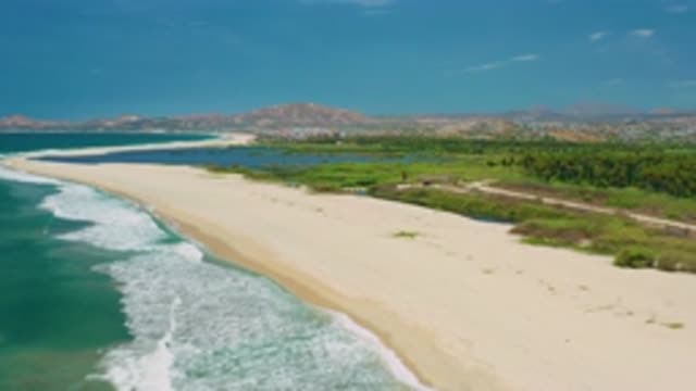 SAN JOSE DEL CABO MEXICO-2020: Beach Surrounded By Hills And Blue Sky