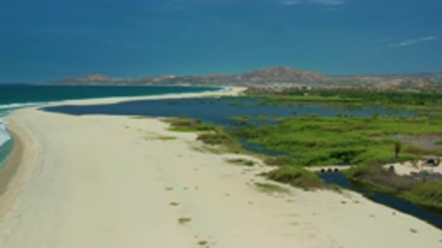 SAN JOSE DEL CABO MEXICO-2020: Winding Beach Path Approaching Mountains Bordered