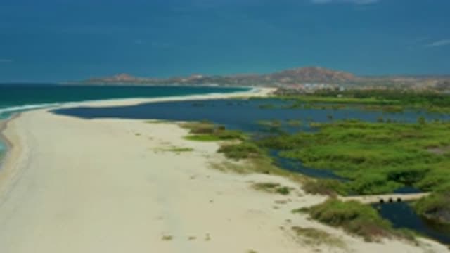 SAN JOSE DEL CABO MEXICO-2020: A Sandy Beach Splits The Ocean From A Tidal Marsh