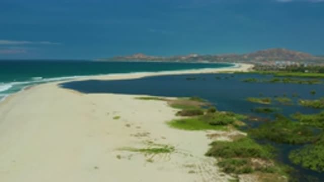 SAN JOSE DEL CABO MEXICO-2020: Blue Sea Water With Mild White Waves Soft Sand