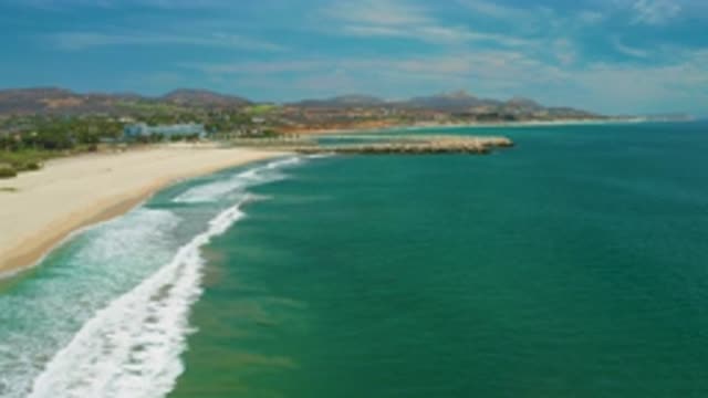 SAN JOSE DEL CABO MEXICO-2020: Blue Green Waves Wash Against Sandy Shore