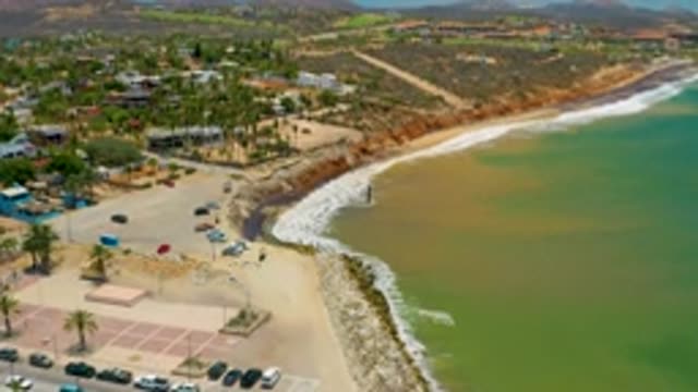 SAN JOSE DEL CABO MEXICO-2020: Green Sea Washes Against Shore Filled With