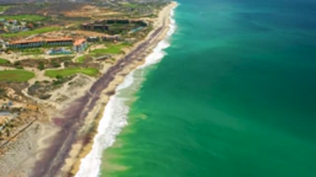 SAN JOSE DEL CABO MEXICO-2020: Green Sea Water White Hitting The Beach