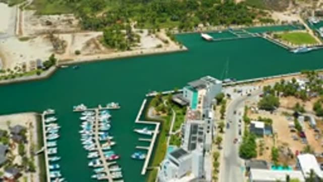 SAN JOSE DEL CABO MEXICO-2020: Cars Driving By A Harbor With Boats Docked In It