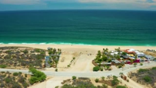 SAN JOSE DEL CABO MEXICO-2020: Passing Over Beach With Trees And Buildings