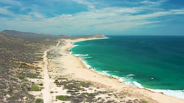 SAN JOSE DEL CABO MEXICO-2020: Aerial View Of Waves Lapping Tropical Beach Road
