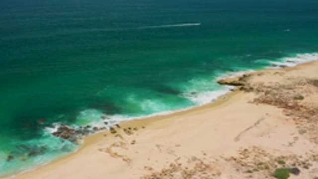 SAN JOSE DEL CABO MEXICO-2020: Jet Skier Near A Rocky Coastline Beach With