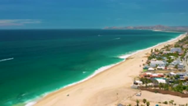 SAN JOSE DEL CABO MEXICO-2020: Sea Green Waves Coming Onto Sandy Beach With
