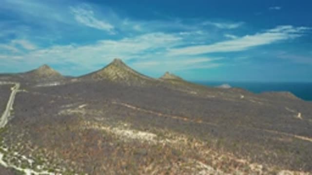 SAN JOSE DEL CABO MEXICO-2020: Small Brown Mountains With Pointy Peaks Against