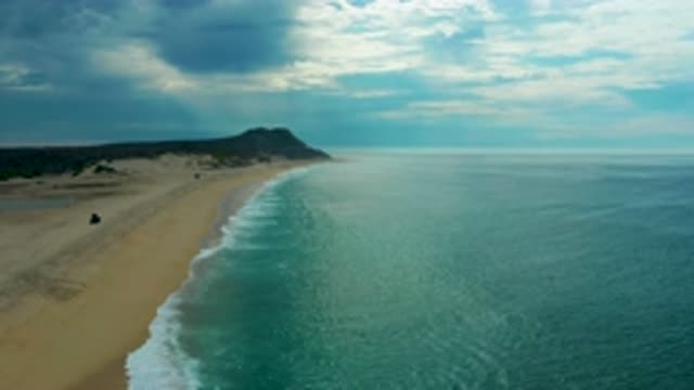 LAGUNA BEACH BCS MEXICO-2020: Oceanside Scene With Sandy Beaches And Cloudy Blue Skies