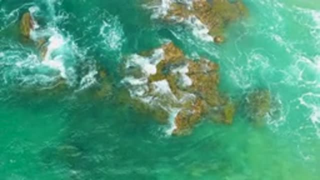 LAGUNA BEACH BCS MEXICO-2020: Bird's Eye View Of Green Ocean Waves Running Over Rocks