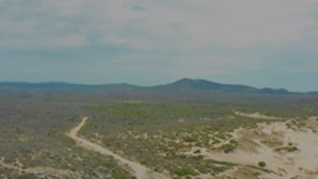 LAGUNA BEACH BCS MEXICO-2020: Mountain Lined Cloudy Sky Sits Midst Sandy Trail