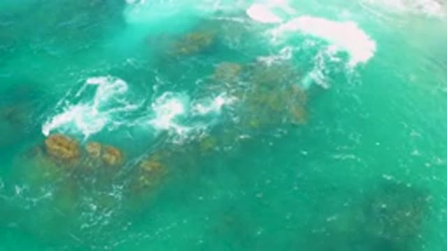 LAGUNA BEACH BCS MEXICO-2020: Sea Waves Floating and Hitting Rocks Colored Green