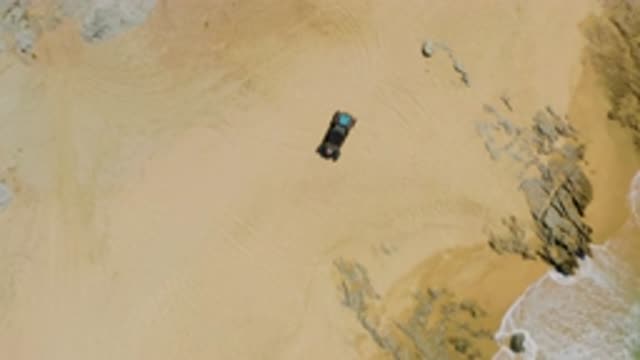 LAGUNA BEACH BCS MEXICO-2020: Car On Sandy Beach With Tire Tracks Going In Circles