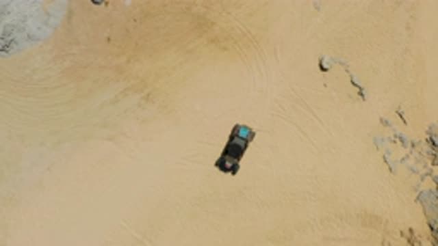 LAGUNA BEACH BCS MEXICO-2020: An SUV Driving Through Desert Surrounded By Rocks and Sand