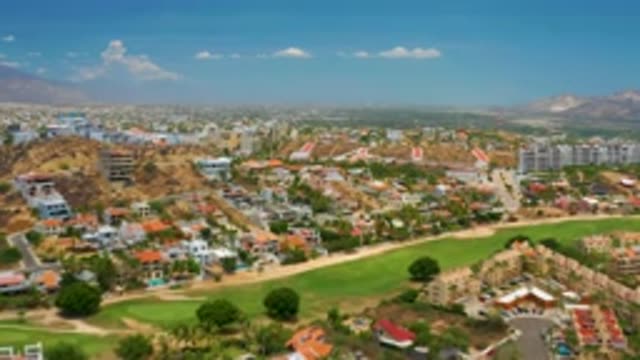 PALMILLA BEACH BCS MEXICO-2020: Lot of White Tall Buildings with Mountains Behind