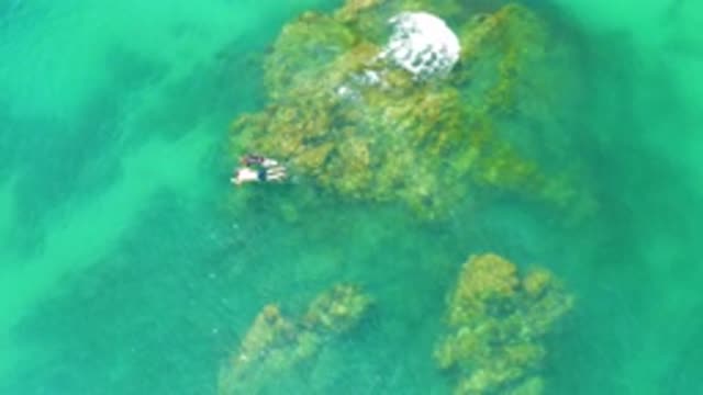 PALMILLA BEACH BCS MEXICO-2020: Two White People Swim Together Over A Shallow Reef