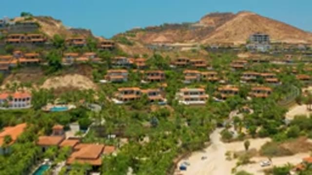 PALMILLA BEACH BCS MEXICO-2020: Blue Water Pool in Center of Resort Lot with Trees and Buildings