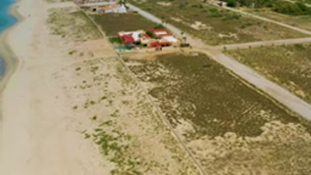 LA RIBERA BCS MEXICO-2020: Red Buildings Along Blue Sea and Sandy Shore
