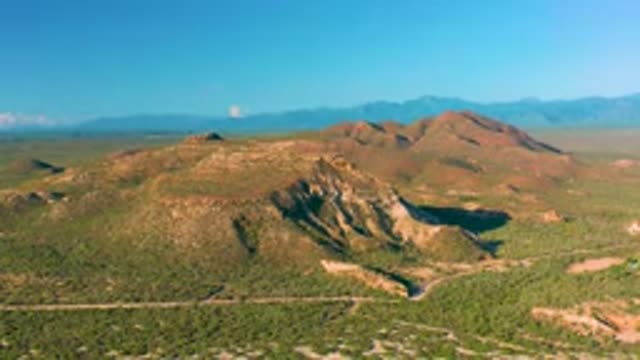 LA RIBERA BCS MEXICO-2020: Lengthy Muddy Road with Green Bushes on Both Sides