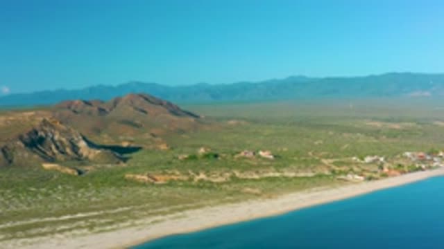 LA RIBERA BCS MEXICO-2020: A Calm Sea Gently Washing On A Beach Behind Mountainous Terrain