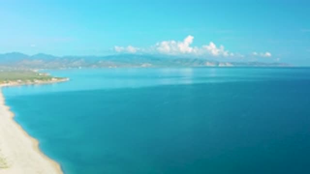 LA RIBERA BCS MEXICO-2020: Clouds Hover Above Mountains Behind Open Blue Sea And