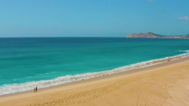 DREAMS BEACH BCS MEXICO-2020: Waves Touching Shore as Two Men Walk