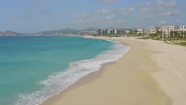 DREAMS BEACH BCS MEXICO-2020: Blue Water Washes Against Sandy Shore Filled With