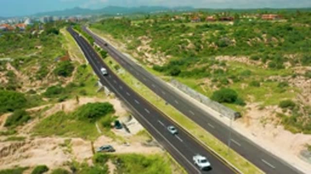 DREAMS BEACH BCS MEXICO-2020: Cars Driving Down Highway In The Middle Of Lush Hills