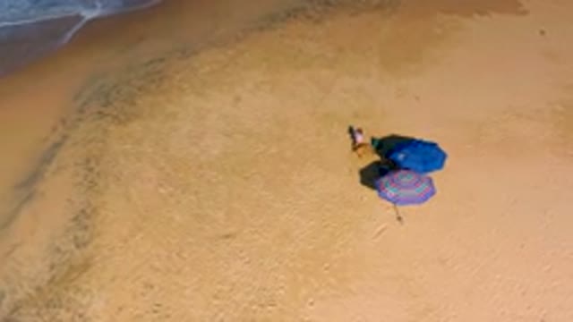 Aerial View of Beach Umbrella and Towel