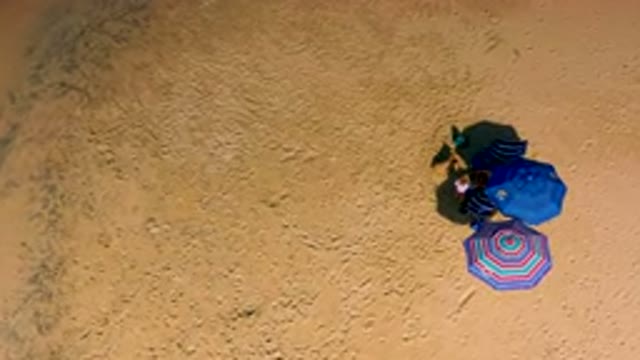 Top Down View of Beach Umbrellas on Sand