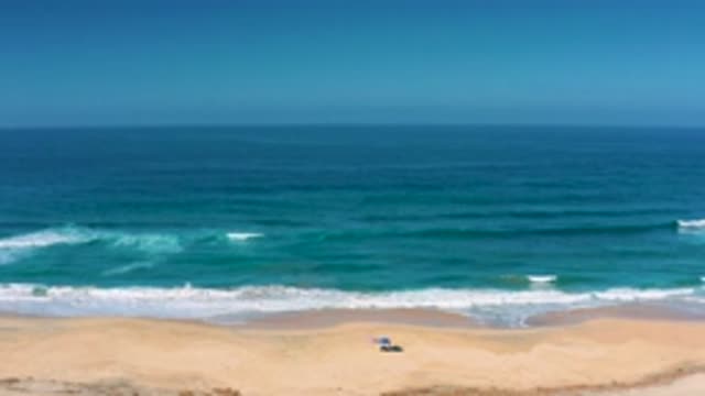 CERRITOS BCS MEXICO-2020: Sea Waves Roll Onto A Sandy Beach Creating White Foam