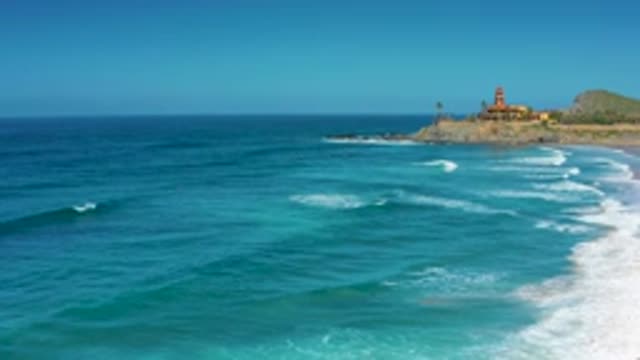 CERRITOS BCS MEXICO-2020: Clear Blue Skies Gentle Waves Roll Up To Small Bluff