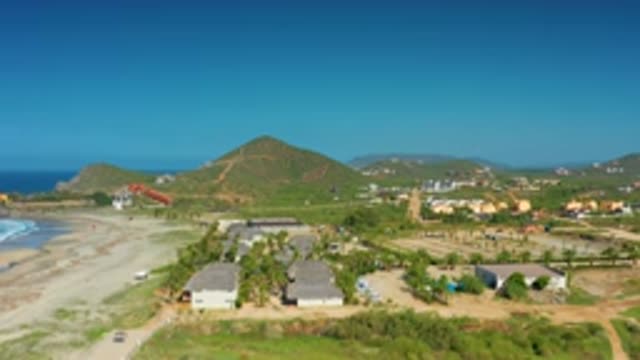 CERRITOS BCS MEXICO-2020: Small Hut-Like Houses with White Waves Hitting Mountains