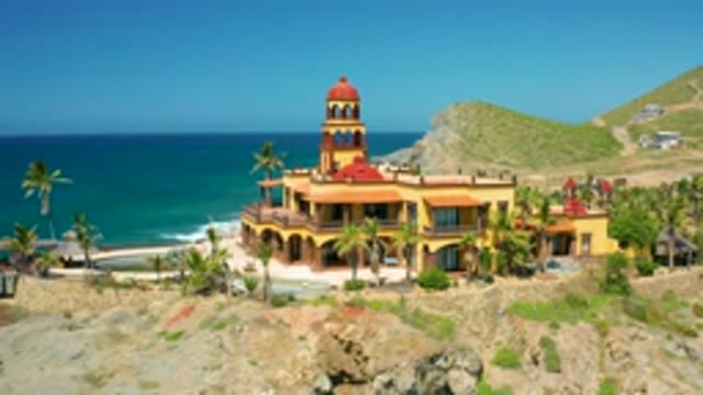 CERRITOS BCS MEXICO-2020: A Decorative Two-Story Building With A Tower On Its Beach